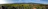 A panoramic view of the spacious 12,000 square meter land area under clear blue skies.