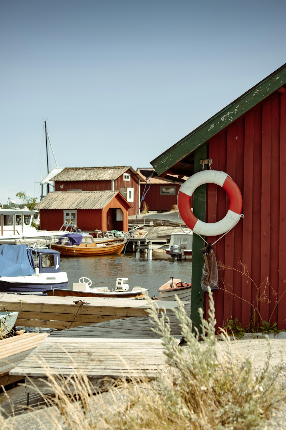 a dock with boats and a life preserver