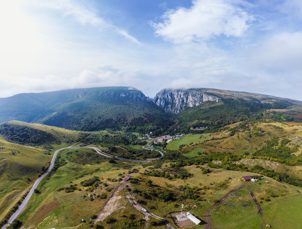 an aerial view of a road winding through a valley