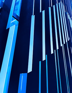 Vertical blue and black panels create a striking modern architectural pattern, with a geometric and abstract design.