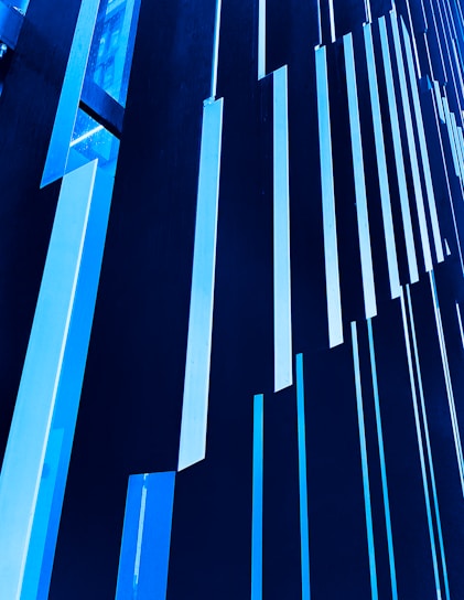 Vertical blue and black panels create a striking modern architectural pattern, with a geometric and abstract design.