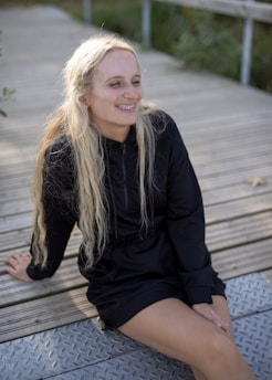 Happy teenager showing off a straight smile after Invisalign treatment in a casual outdoor setting.