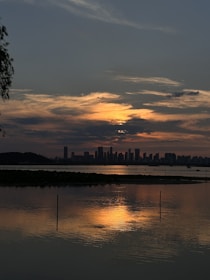 A peaceful outdoor scene of an Indonesian city skyline at sunset.