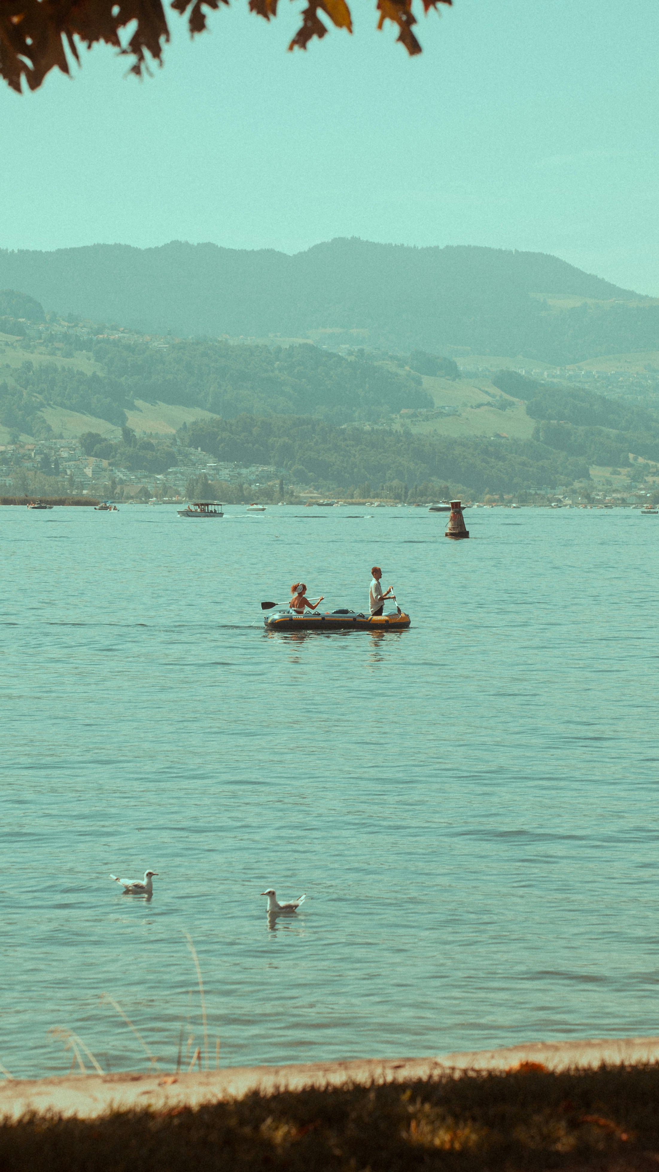 a group of people in a small boat on a lake