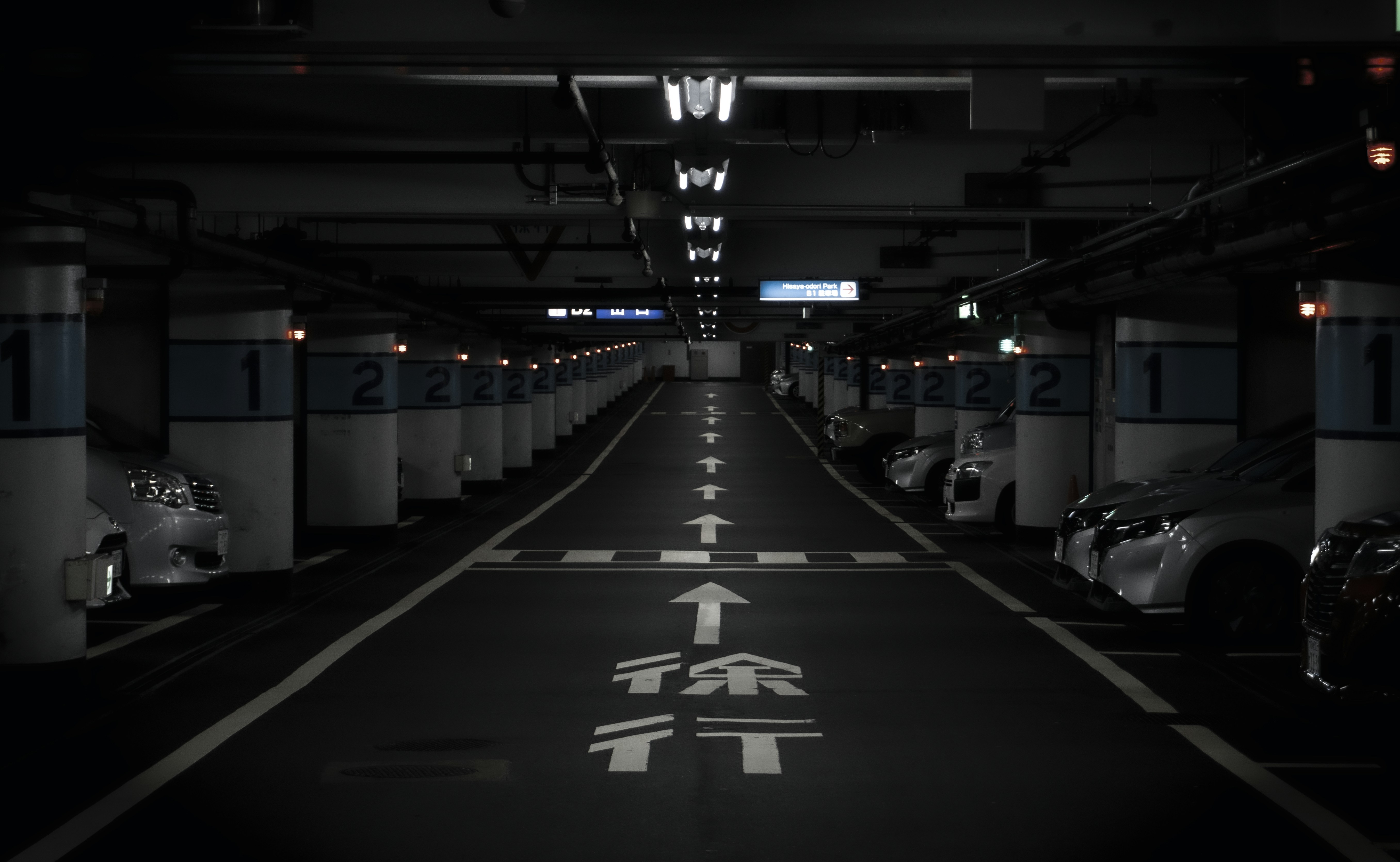 an empty parking garage filled with lots of parked cars