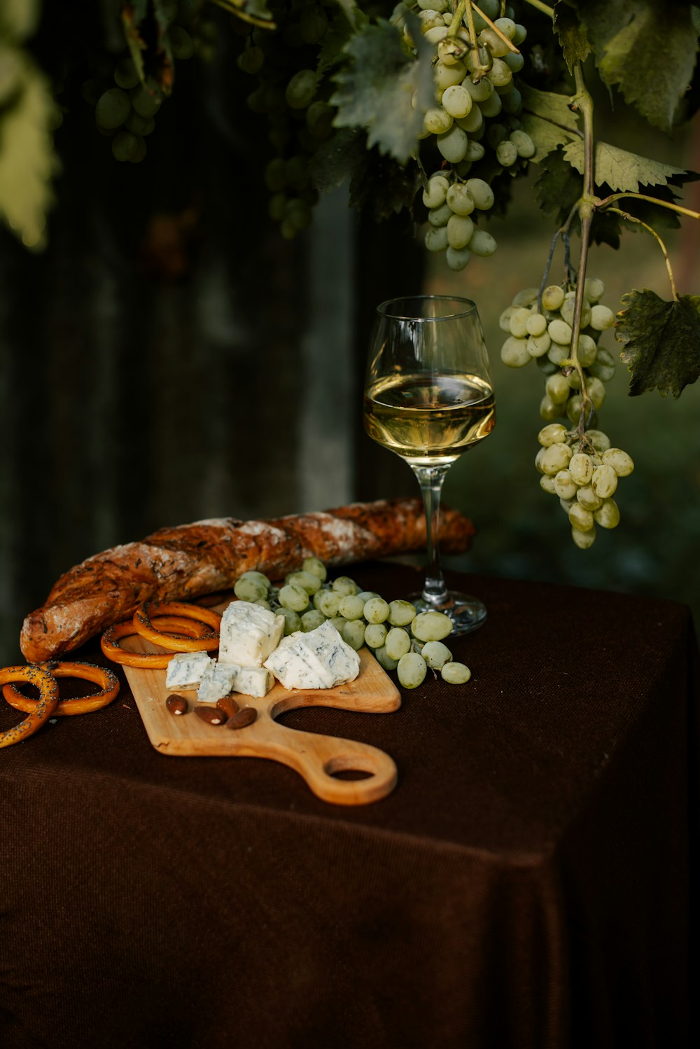 a glass of wine and some food on a table