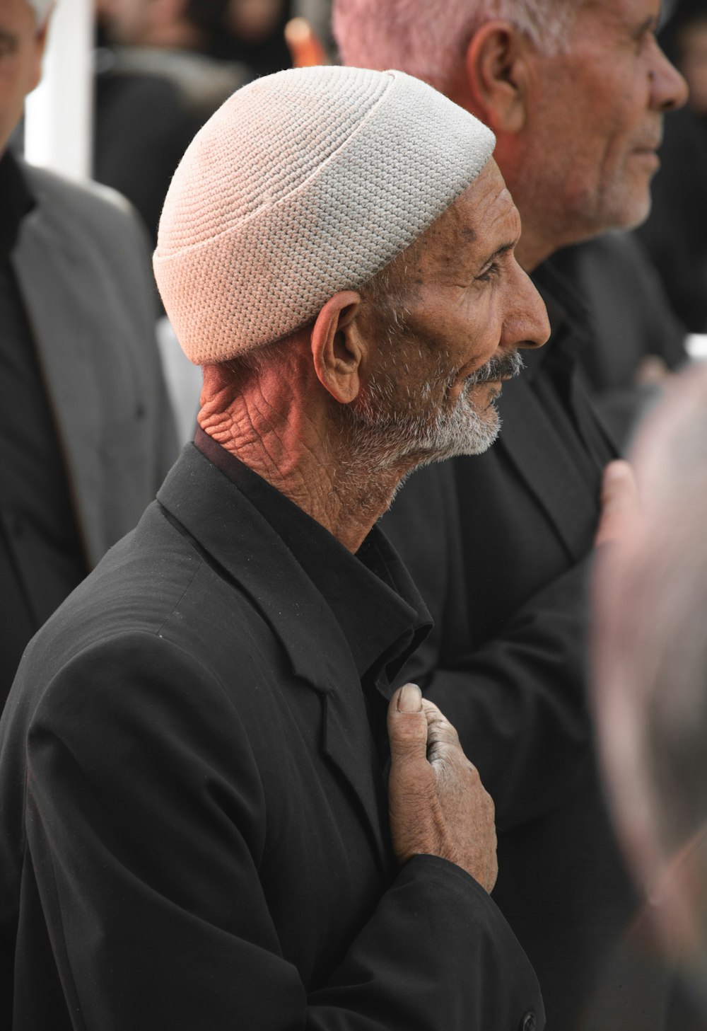 a man with a white turban standing next to another man