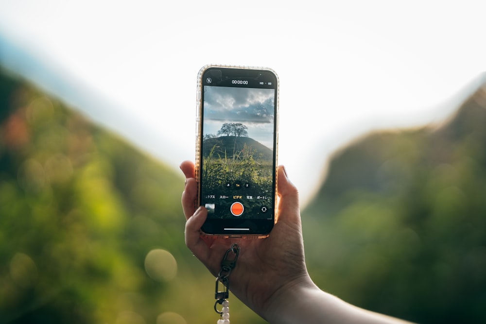 a person taking a picture with a cell phone