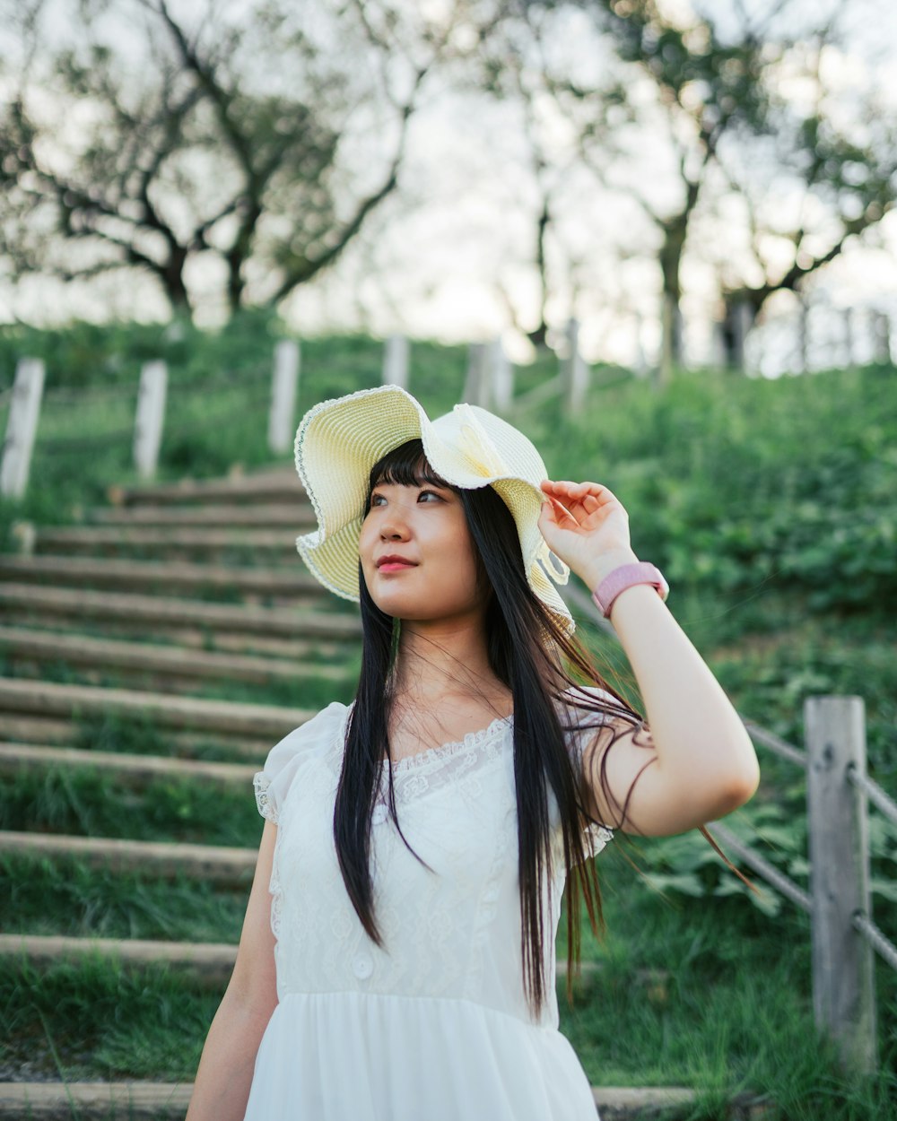 a woman in a white dress and a yellow hat