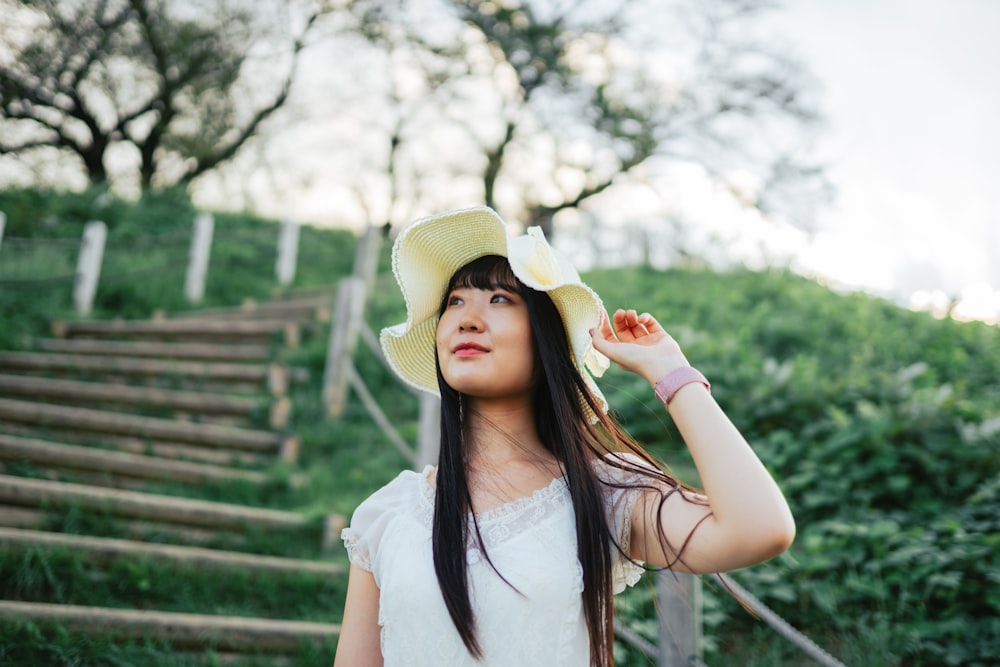 a woman in a white dress and a yellow hat