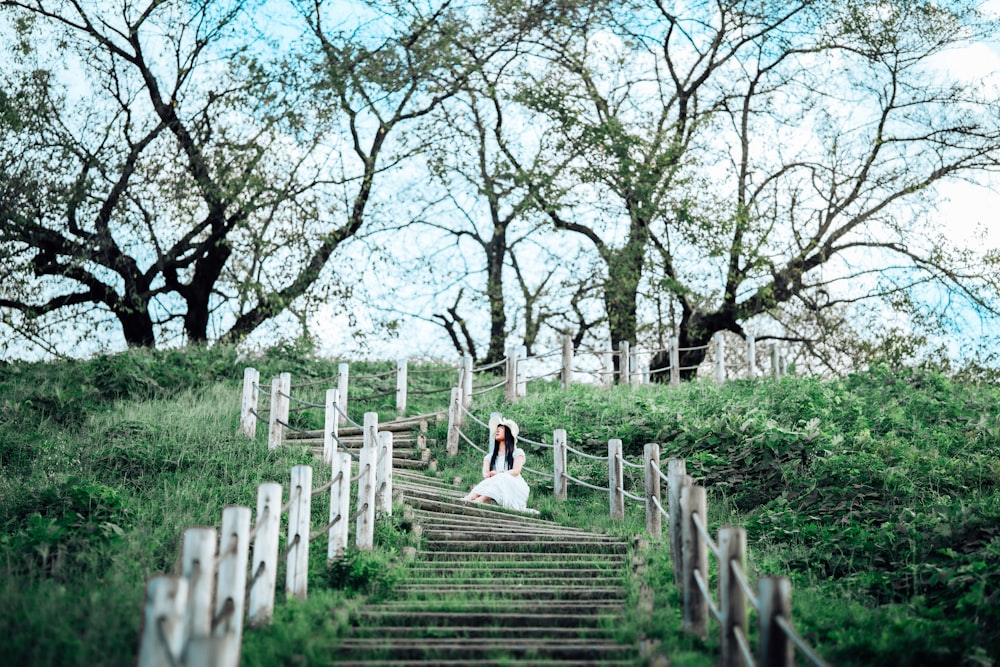 a bride and groom walking down a set of stairs