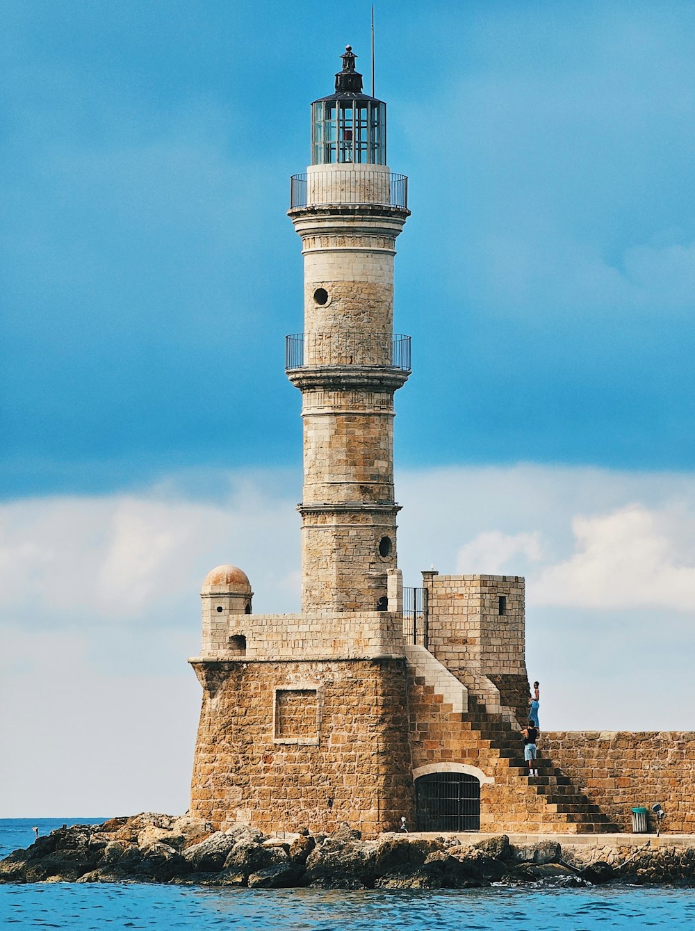 a light house sitting on top of a small island