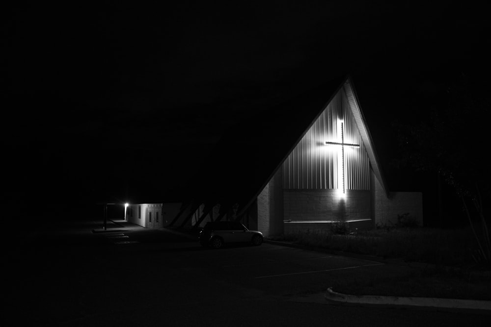 a black and white photo of a church at night