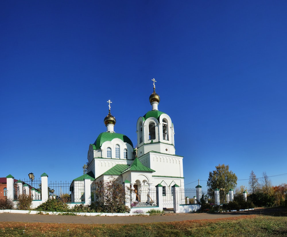 a large white and green church with two towers