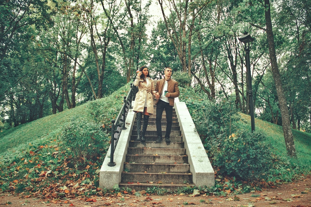 a couple of people that are standing on some stairs