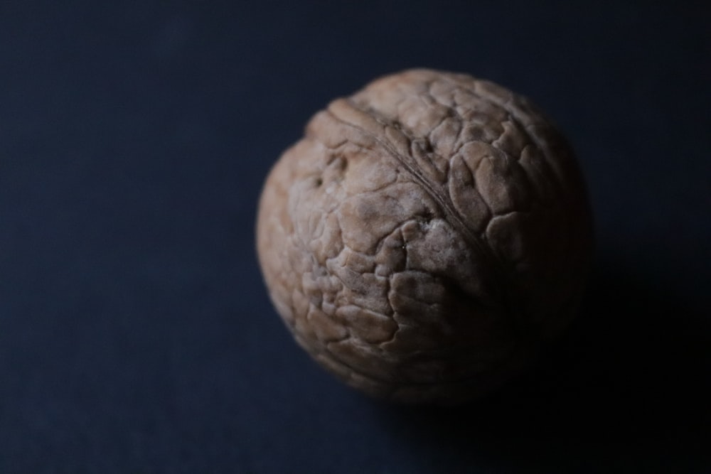 a close up of a walnut on a black background