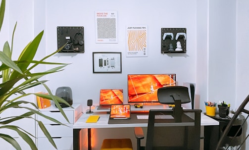 a desk with two monitors and a keyboard
