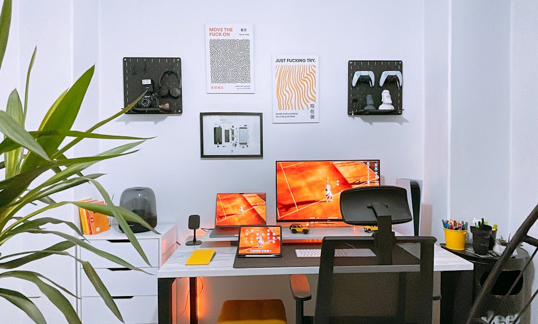 a desk with two monitors and a keyboard,
