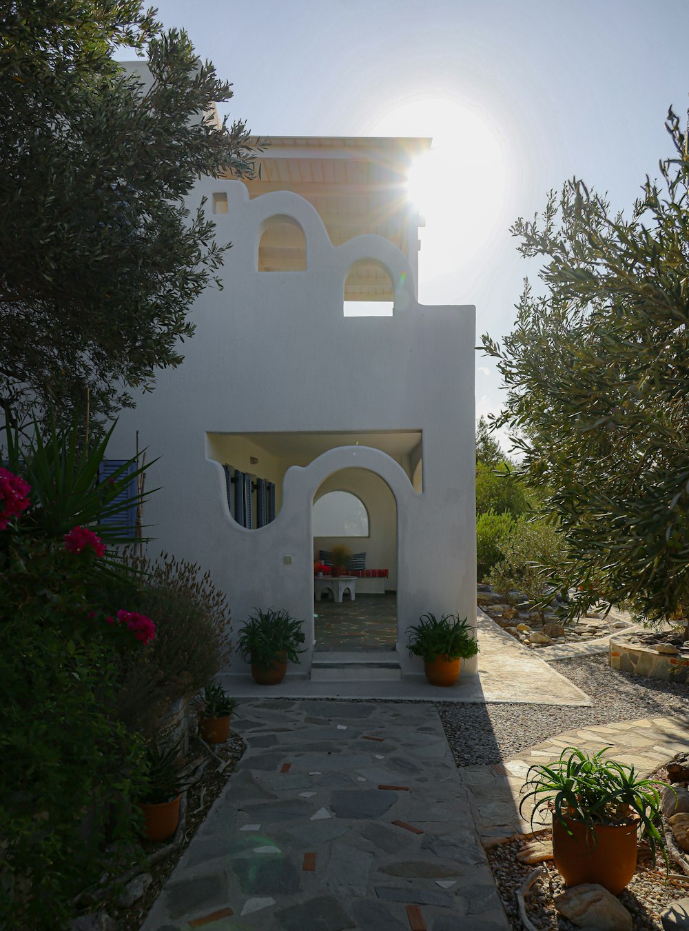 a white house with a stone pathway leading to it