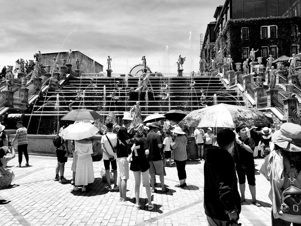 a black and white photo of people with umbrellas