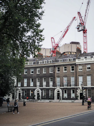 a large brick building with a crane on top of it