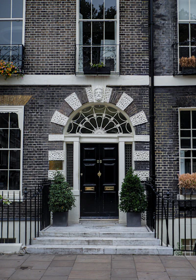 a building with a black door and a black fence