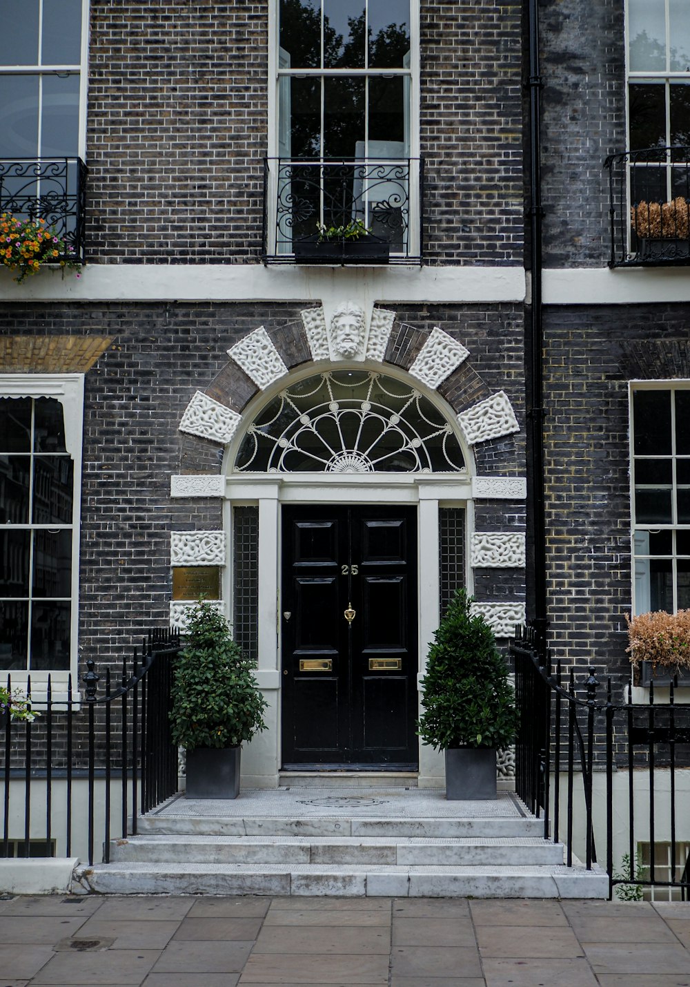 a building with a black door and a black fence