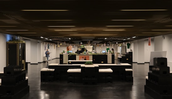 A cozy, modern restaurant interior with a wooden counter displaying colorful pokè bowls and gourmet burgers.