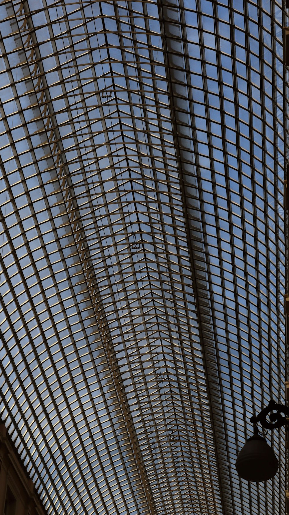 the ceiling of a building with a clock on it