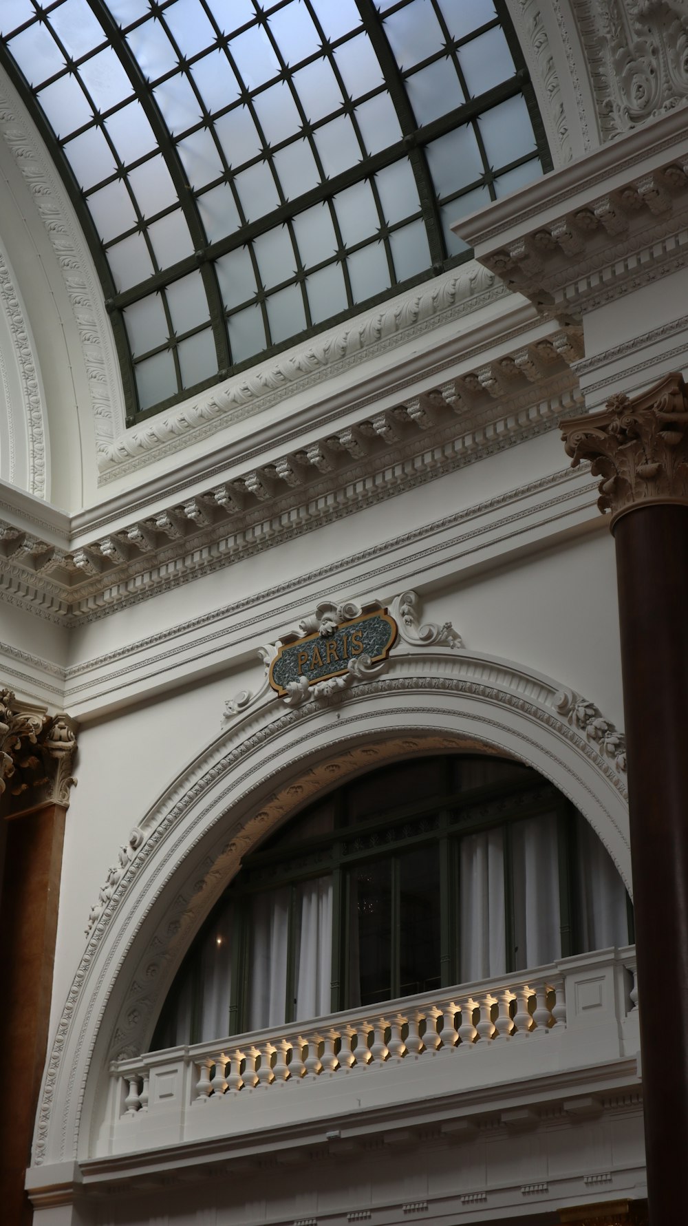 a building with a glass roof and a clock