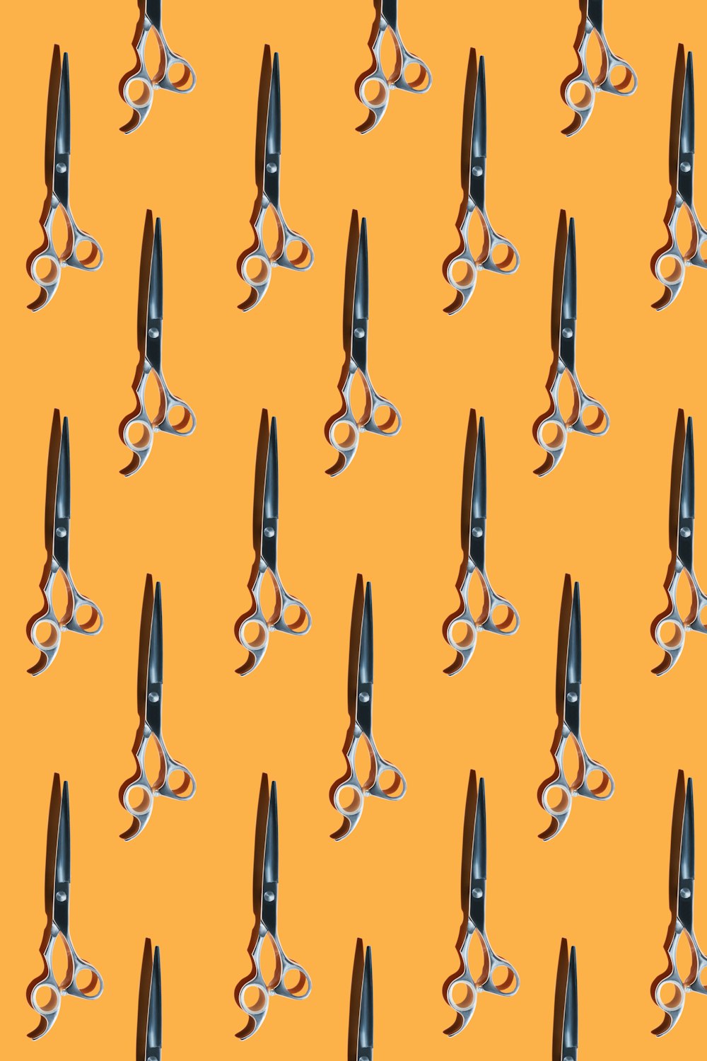 a bunch of scissors that are on a yellow background
