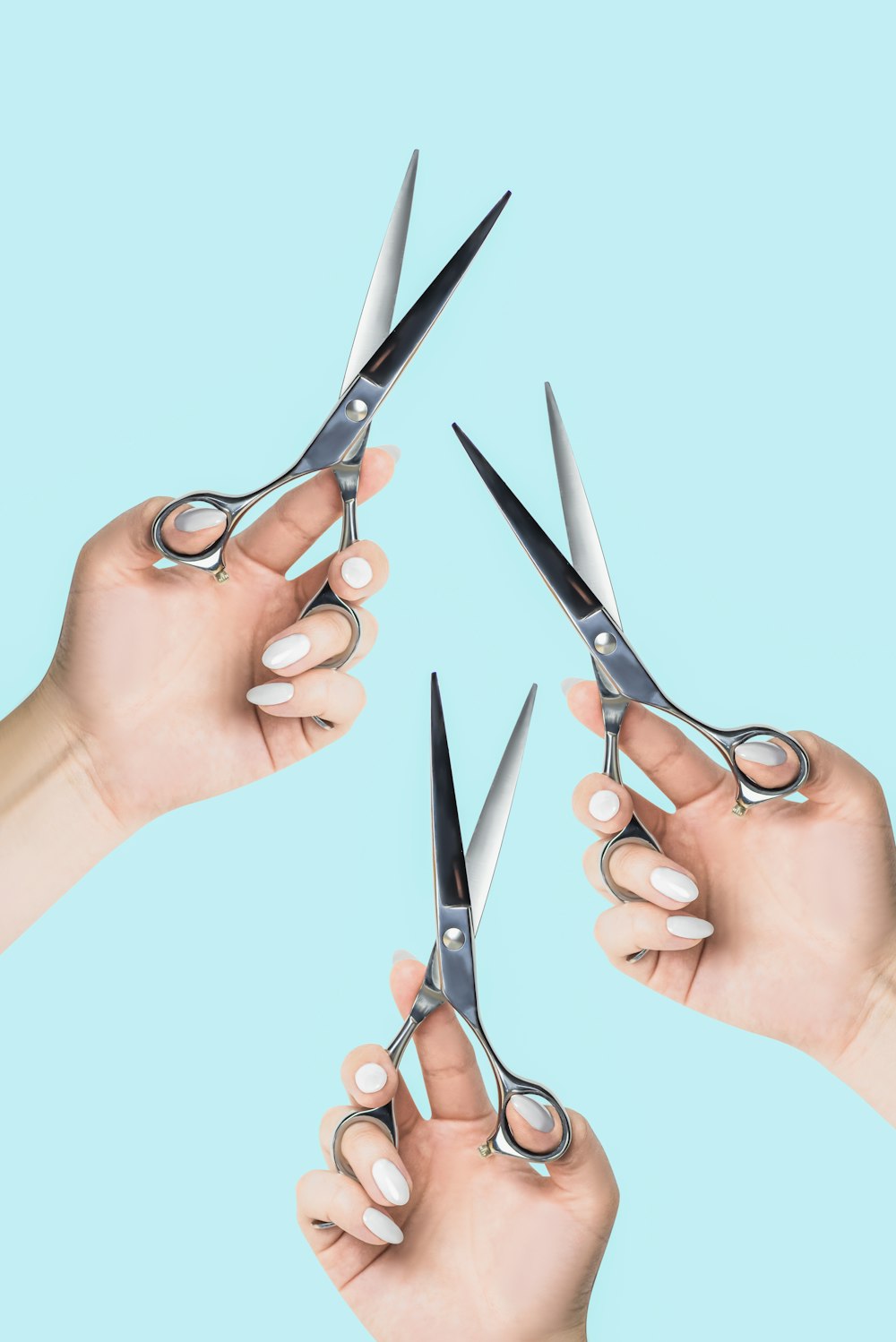 a pair of hands holding a pair of scissors