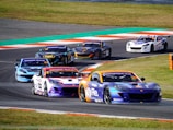 a group of cars racing on a race track
