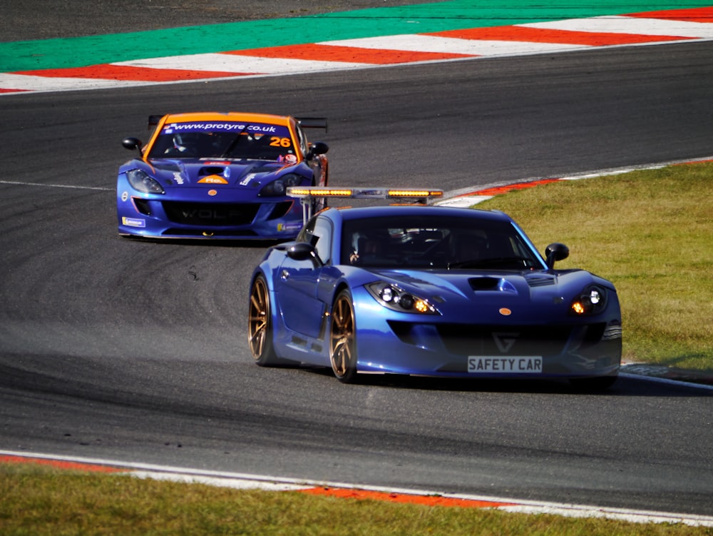 two racing cars driving on a race track