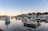 Sunlit balcony overlooking the serene harbor with boats gently bobbing.