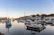 Sunlit balcony overlooking the serene harbor with boats gently bobbing.
