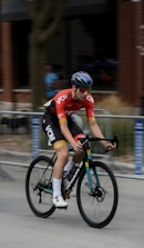 a man riding a bike down a street
