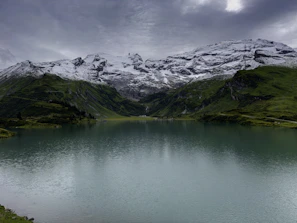 A serene mountain landscape with a traveler admiring the view, evoking peaceful escape.