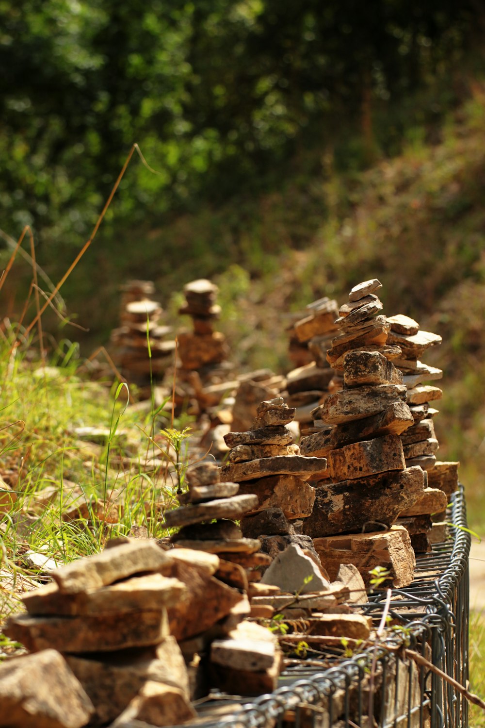 a bunch of rocks sitting on top of a fence