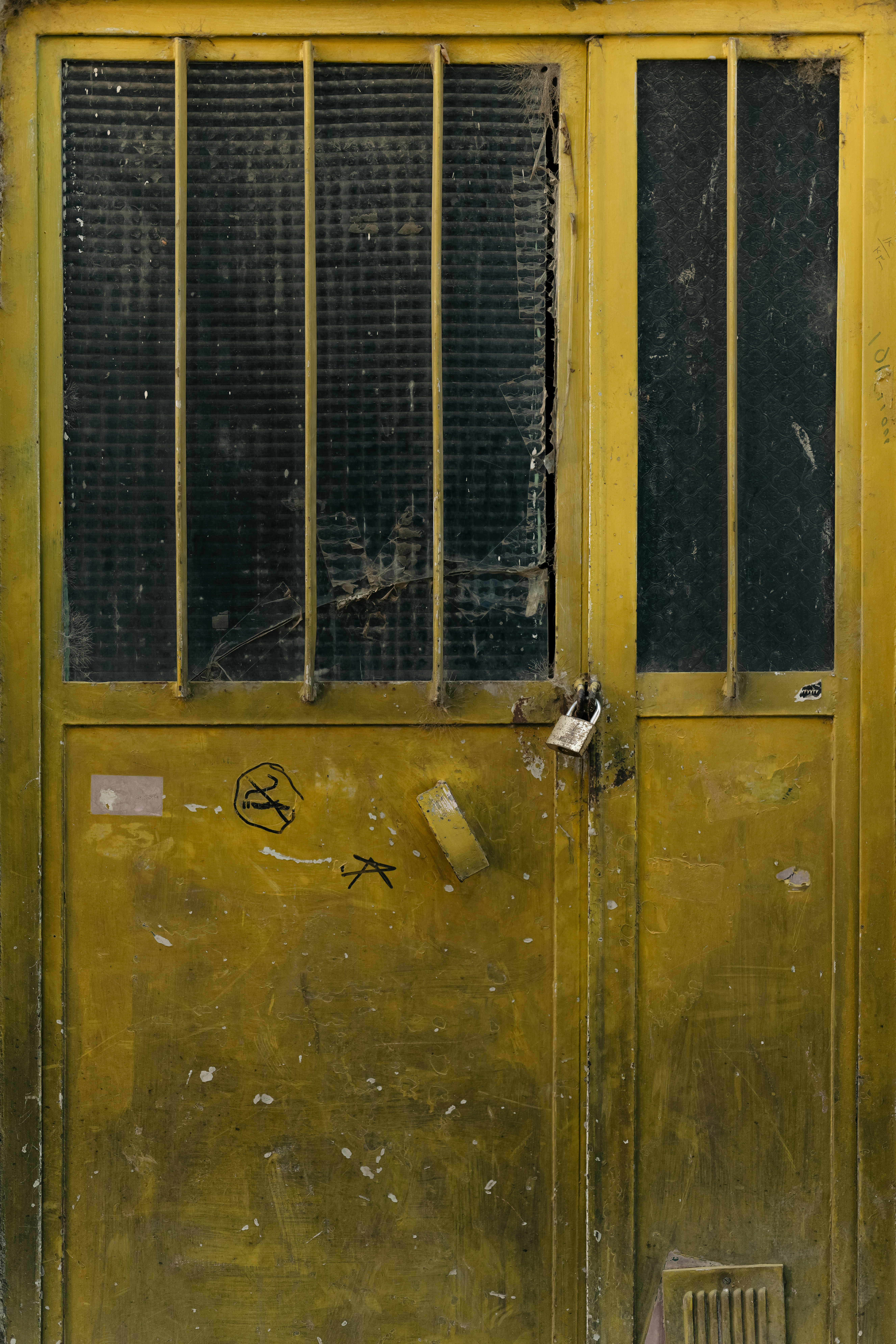 a yellow door with a window on the side of it