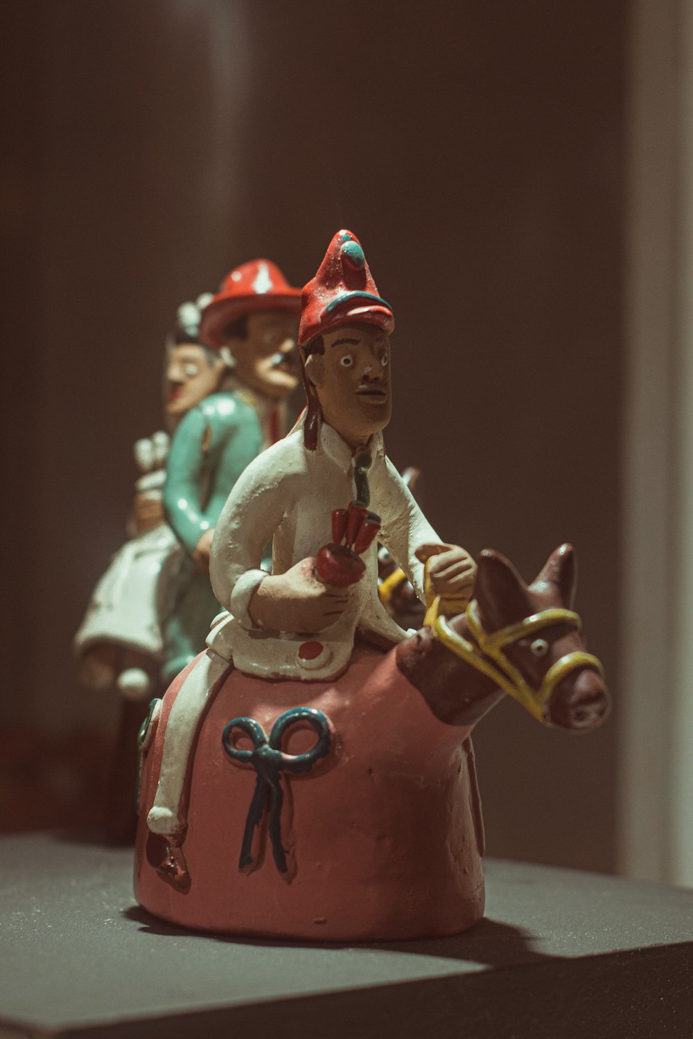 a figurine of a man riding a horse