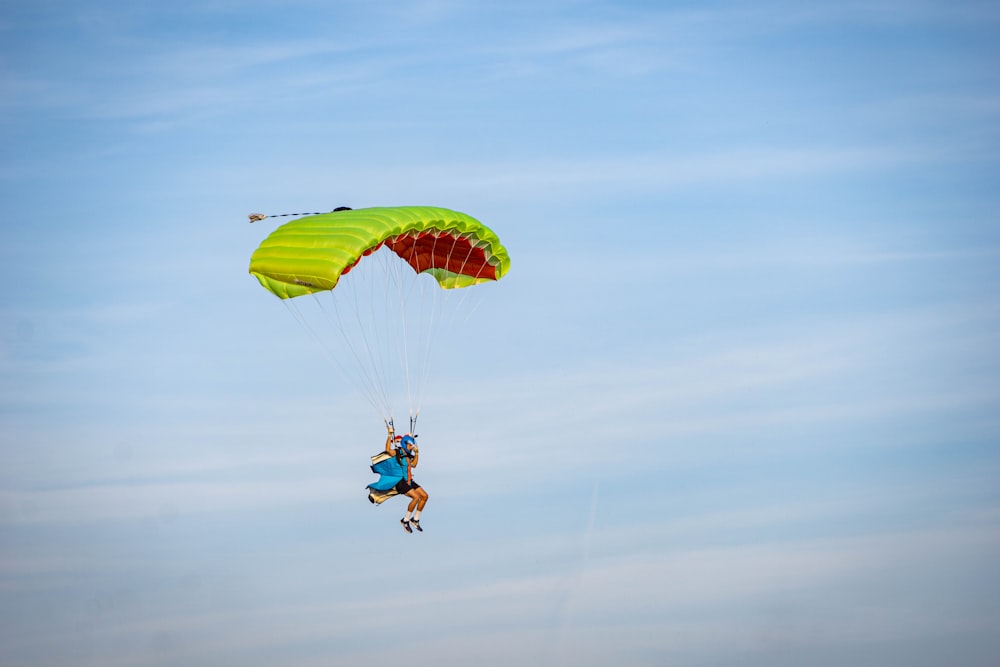 two people are parasailing in the sky on a sunny day
