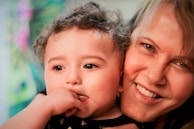 Close-up of a professional photographer capturing a smiling child with a colorful backdrop.