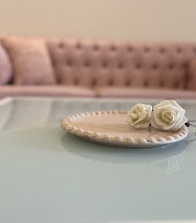 A decorative plate in a cozy bedroom setting.