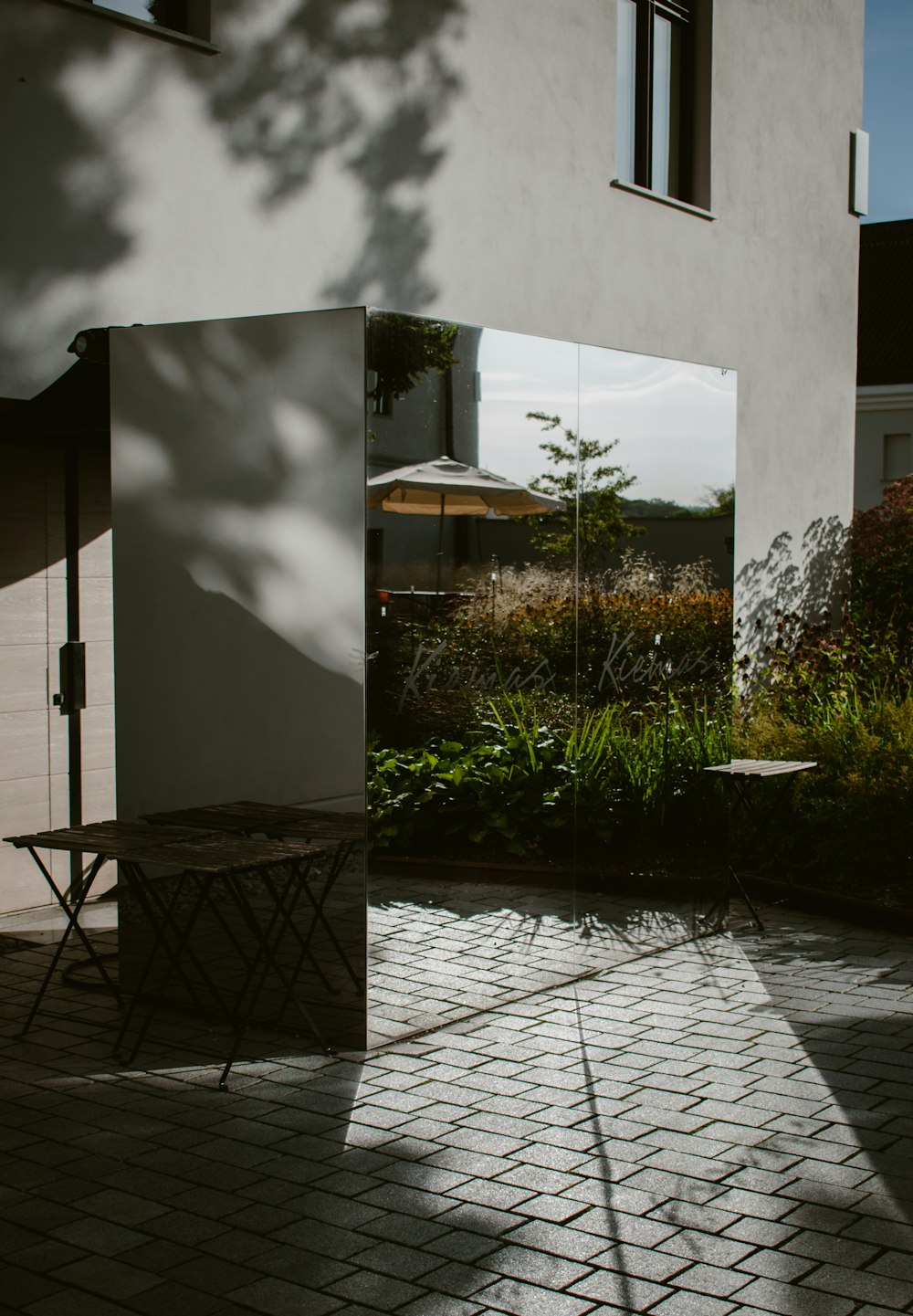 a white building with a mirror on the side of it