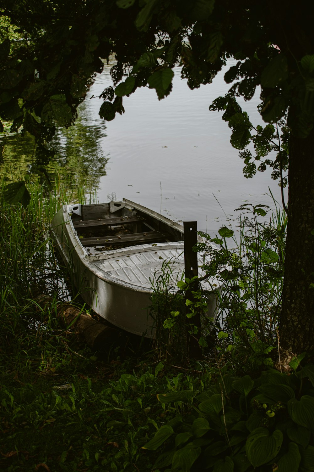 a small boat sitting on top of a body of water