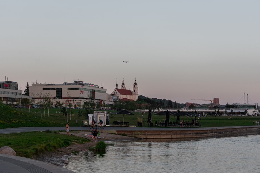 a body of water with a plane flying over it