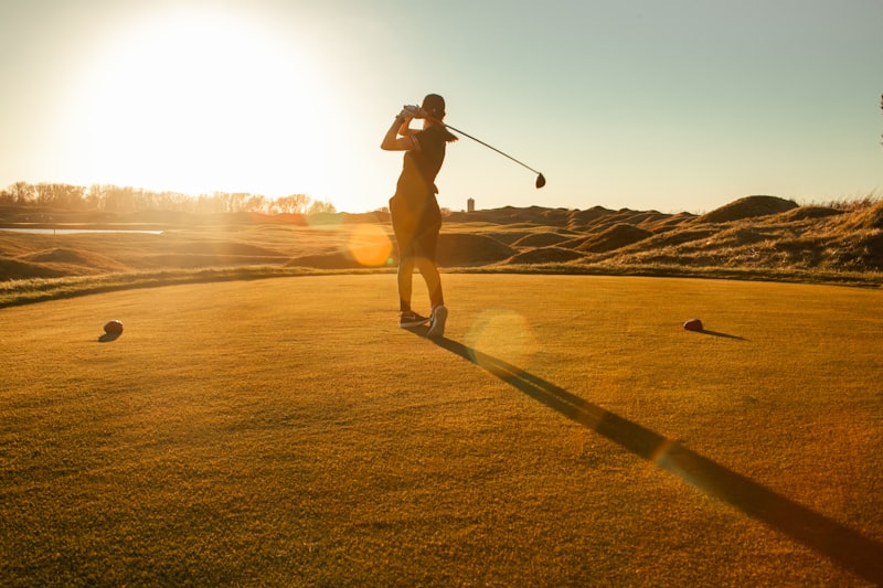 Golfer mid-swing on a course