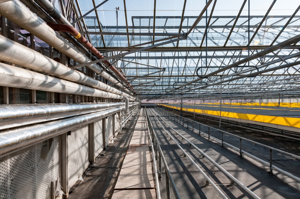 a train traveling through a train station under a blue sky