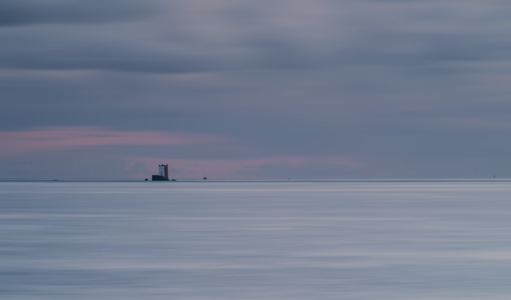 a lighthouse in the middle of a large body of water